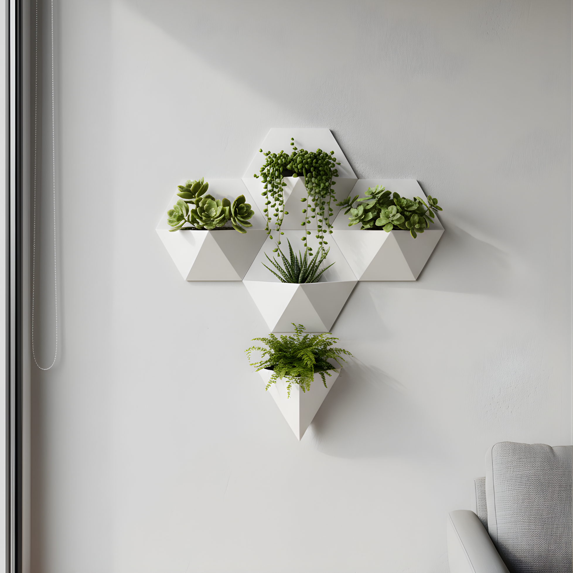 Geometric wall planters with plants on a light gray wall.
